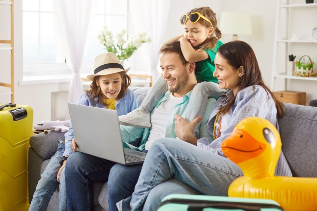 Family planning vacation on laptop checking pollen levels and hospitals